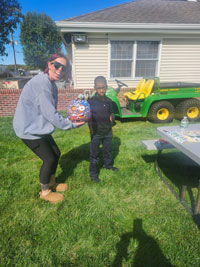 Staff member and tenant posing with painted pumpkin