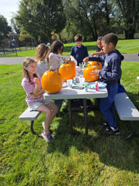 Children painting pumpkins a different angle